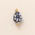 Macro view of blue and white floral ceramic bead pendant with 18K gold-plated fittings - Enamel Pendant Style A