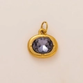 Macro shot of oval gold-plated pendant with faceted purple gemstone and top connector ring - Oval Birthstone Pendant / February