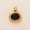 Macro shot of 18K gold plated birthstone charm with oval blue gem and top hanging ring - Oval Birthstone Pendant / September