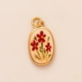 Macro shot of oval gold-plated pendant featuring red floral enamel and vintage details - Pendant Only / Oval Red Flower Pendant No.13