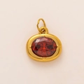 Oval gold-plated birthstone pendant featuring a faceted red ruby-colored crystal inlay - Oval Birthstone Pendant / Inlay / January