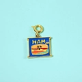 Detailed macro view of a square blue enamel burger charm with a gold-plated spring clasp - Hamburger Pendant