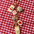 Détail macro du porte-clés à breloques avec pendentifs cerise fraise et marguerite - Pendentif Fleur Blanche