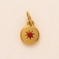 Detail of 18K gold plated round pendant featuring a red birthstone and starburst design - July Birthstone Pendant
