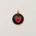Detailed view of a black round pendant with a red heart and golden beaded edge - Guardian Heart Pendant