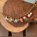 Golden sea-themed charm bracelet with coral shells and starfish on wood background - Style 2 Marine Theme Necklace Set (Includes Chain and Pendants)