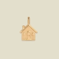 Detailed macro view of a golden house-shaped pendant with carved windows and tiny chimney - Home House Pendant