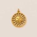 Macro shot of 18K gold sun face relief pendant with radiant openwork rays design - Sun Pendant