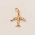 Detailed view of an 18K gold-plated airplane pendant with sparkling inlaid rhinestones - Airplane Shape Rhinestone Pendant