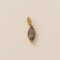 Macro shot of marquise-cut lavender stone pendant in vintage gold-plated frame - February Birthstone Pendant
