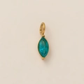 Detailed close-up of a marquise-cut blue gemstone pendant with a polished gold frame - March Birthstone Pendant