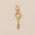 Detailed view of a golden key pendant featuring a delicate four-leaf clover head design - No.1 Key Pendant