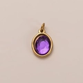 Close-up of an oval purple faceted gemstone pendant with gold plated stainless steel bezel - February Birthstone Pendant