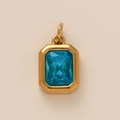 Detail of emerald-cut sky blue crystal pendant with polished gold metal frame - Simple Rectangular Glass Pendant / Gold-Blue