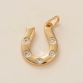 Detail of a gold horseshoe pendant with five round white gemstones on beige background - Horseshoe Pendant Only (Without Chain)