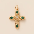 Detailed macro shot of a vintage gold cross pendant with emerald green gemstones - Cross Pendant