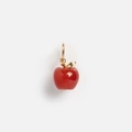 Macro shot of red apple pendant with gold leaf detail and high-gloss enamel finish - Apple