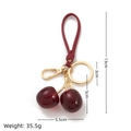 Charm borsa ciliegia in resina glitterata rosso scuro con moschettone dorato - Ciliegia Rosso Scuro