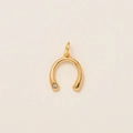 Detailed view of a horseshoe pendant in 14k gold plated copper with white cubic zirconia - Inverted U-Shape