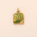 Macro detail of toast and avocado pendant with 18K gold plating and green enamel finish - Gold Toast Pendant