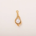 Detailed macro of a 18K gold-plated irregular organic pendant with a white pearl inlay - Pearl Conch Pendant