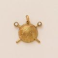 Detail of a golden yarn ball pendant with crystal-studded needles and a polished finish - Yarn Ball