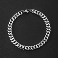 Detail shot of a silver Cuban link bracelet with lobster clasp on black leather background - Cuban Curb Chain / Width 5 Length Adjustable