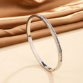 Detailed macro view of silver steel bracelet featuring square-cut channel-set zirconia - Steel