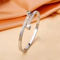 Detailed view of silver steel nail bracelet with sparkling cubic zirconia on orange silk - Double-ended Nail - Steel Color Sz446