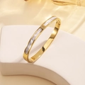 Macro shot of 18K gold plated steel bangle with shell inlay and three small rhinestones - Shell Bangle-Gold (A628) / Gold