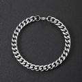 Detailed close-up of a polished silver stainless steel Cuban link bracelet with lobster clasp - Fine Style / Steel