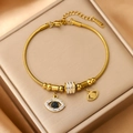 Bracciale a serpente da donna in acciaio inossidabile placcato oro 18K con ciondoli - Malocchio / Oro