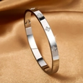 Detailed macro view of silver clover bangle with inset rhinestones on silk fabric - Four-Leaf Clover Zirconia Style (A460) / Steel