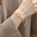 Detailed view of an 18K gold plated clover bracelet with sparkling clear zircon stones - Four-leaf Flower Bracelet-White