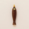 Detailed close-up of a vintage fish pendant with 18K gold plating and green stone eye - Brown Fish Pendant