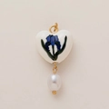 Detail view of heart-shaped ceramic pendant with blue flower pattern and pearl drop - Heart Blue Iris Pearl Pendant