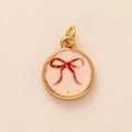 Vintage style gold-plated round pendant featuring a hand-painted red bow design - Pink Bow Pendant