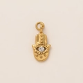Detailed close-up of a 18K gold-plated Hamsa hand pendant with central zircon gemstone - Evil Eye Hamsa Pendant