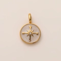 Macro detail of 18K gold-plated compass pendant with star starburst and zircon inlay - Compass Pendant