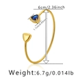 Detail showing the 6cm diameter and 6.7g weight of the gold plated zircon cuff bracelet - Blue Triangle Gemstone Style (KB0385-2)