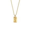Macro shot of gold tarot The Stars pendant with embossed sun, moon, and hand detail - New Tarot Necklace-The Stars