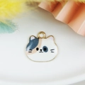 Close-up of cat-shaped alloy pendant with tri-color enamel oil and golden finish - Yellow and White Style