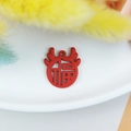 Macro detail of red Chinese New Year DIY charm with Fu character and deer antlers - Red
