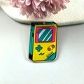 Retro gaming console acrylic keychain pendant with vibrant yellow and pink colors - Game Console