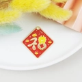 Red enamel diamond-shaped pendant featuring a golden Chinese dragon and Fu character - Daifuku