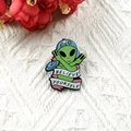 Green alien enamel pin wearing blue star cap and pink ribbon with Believe Yourself text - Baseball Cap Alien Style