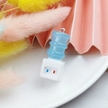 Macro shot of a mini 3D resin water dispenser pendant with detailed blue bucket and base - Water Dispenser