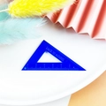 Close-up of blue translucent acrylic triangle ruler with back to school lettering - Triangle Ruler / Dark Blue