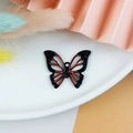 Macro shot of a black and red butterfly alloy pendant for DIY jewelry making - Butterfly Pendant / Red (1)