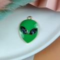 Detailed close-up of green enamel alien charm with blue crystal eyes and gold alloy plating - Green